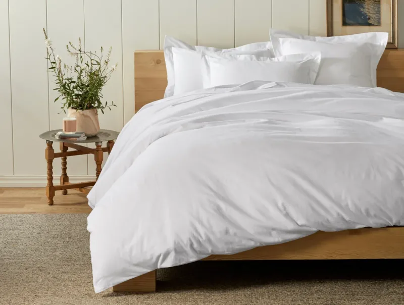 Coyuchi Cloud Brushed Flannel duvet cover in white, styled on a natural wood bed.