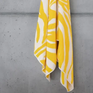 Abyss Habidecor’s Zebra Beach Towel showcases a yellow and white abstract stripe design, crafted from premium Giza Egyptian Cotton.